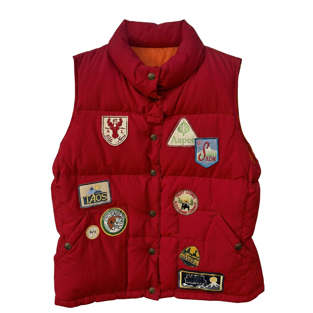 Red puffer vest covered in travel patches